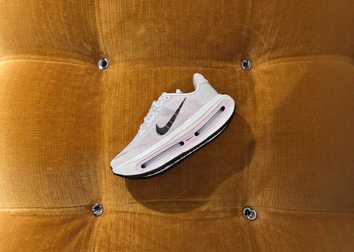 Nike Vomero Premium in white and pink on an orange velvet seat
